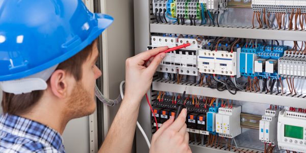 Technician-Examining-Fusebox-With-Multimeter-Probe-510199849_5353x3569